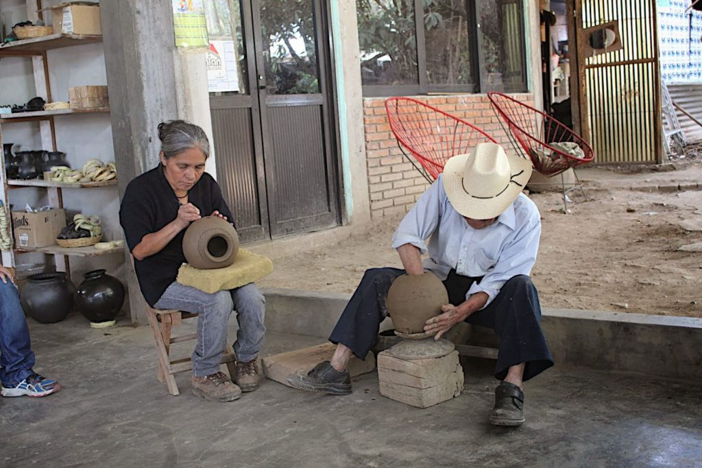 Forming the clay pot and carving it